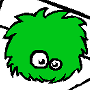 A small green Chuzzle plush. It looks like a non-descript furball with eyes.